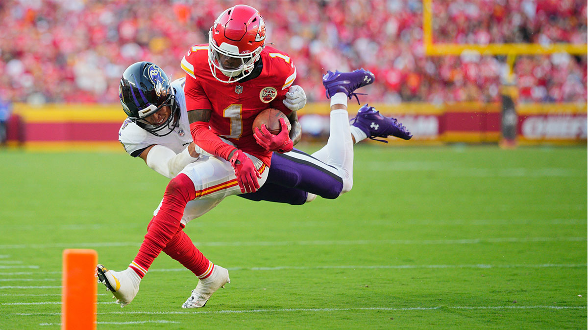 Kansas City Chiefs wide receiver Xavier Worthy (1) runs after making a catch as Baltimore Ravens cornerback Marlon Humphrey (44) defends during the third quarter at GEHA Field at Arrowhead Stadium.