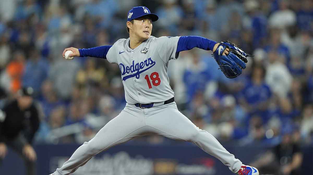 Los Angeles Dodgers pitcher Yoshinobu Yamamoto (18) pitches against the Toronto Blue Jays in the seventh inning during game two of the 2025 MLB World Series at Rogers Centre.