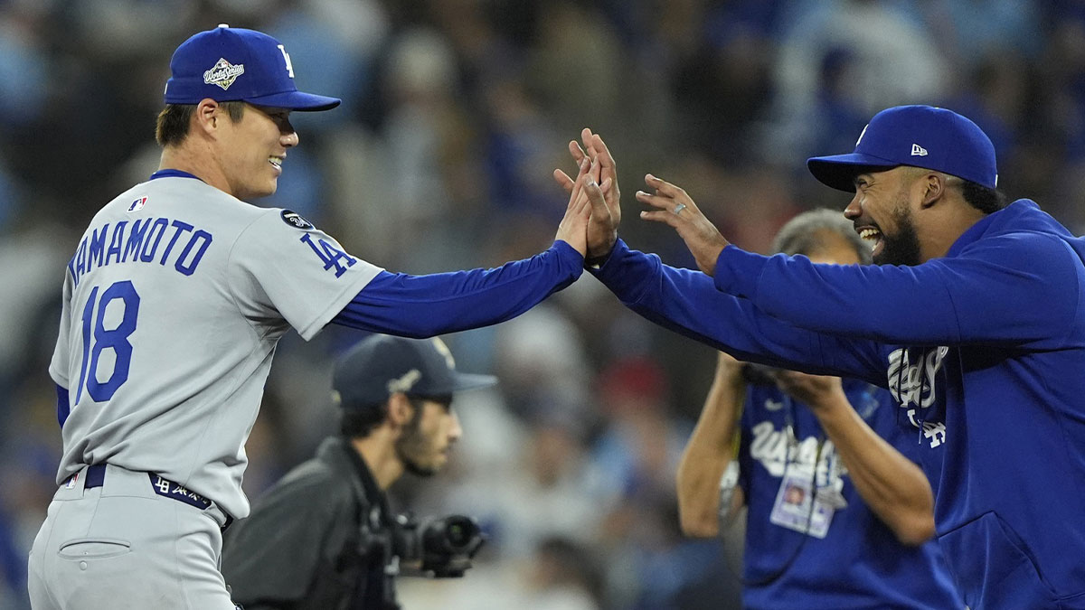 Los Angeles Dodgers pitcher Yoshinobu Yamamoto (18) celebrates with right fielder Teoscar Hernandez (37) after defeating the Toronto Blue Jays in game two of the 2025 MLB World Series at Rogers Centre. Mandatory Credit: John E. Sokolowski-Imagn Images