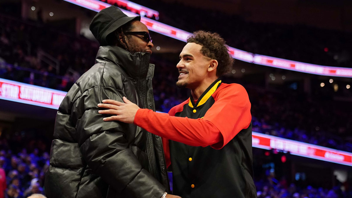 Atlanta Hawks guard Trae Young (11) greets recording artist 2-Chainz before the 3-Point Contest during the 2022 NBA All-Star Saturday Night at Rocket Mortgage Field House.