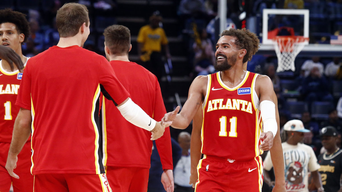Atlanta Hawks guard Trae Young (11) reacts with Atlanta Hawks guard Luke Kennard (3) during a timeout in the third quarter at FedExForum.