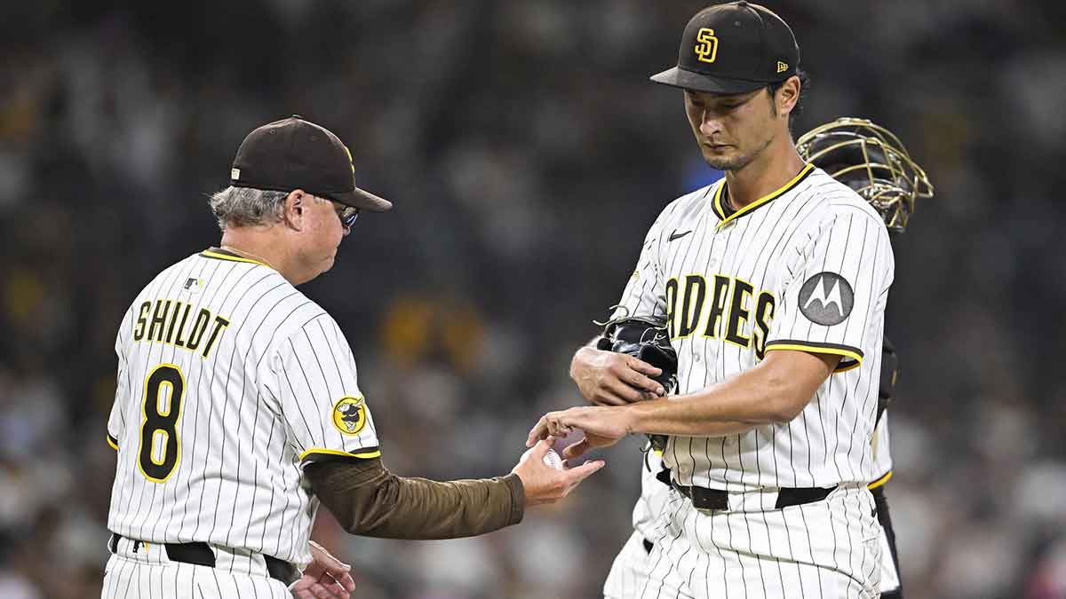 San Diego Padres starting pitcher Yu Darvish (11) hands the ball to manager Mike Shildt (8) as he leaves the game during the fifth inning against the Baltimore Orioles at Petco Park.