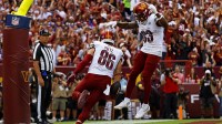 Washington Commanders tight end Zach Ertz (86) scores a touchdown during the first quarter against the New York Giants at Northwest Stadium.