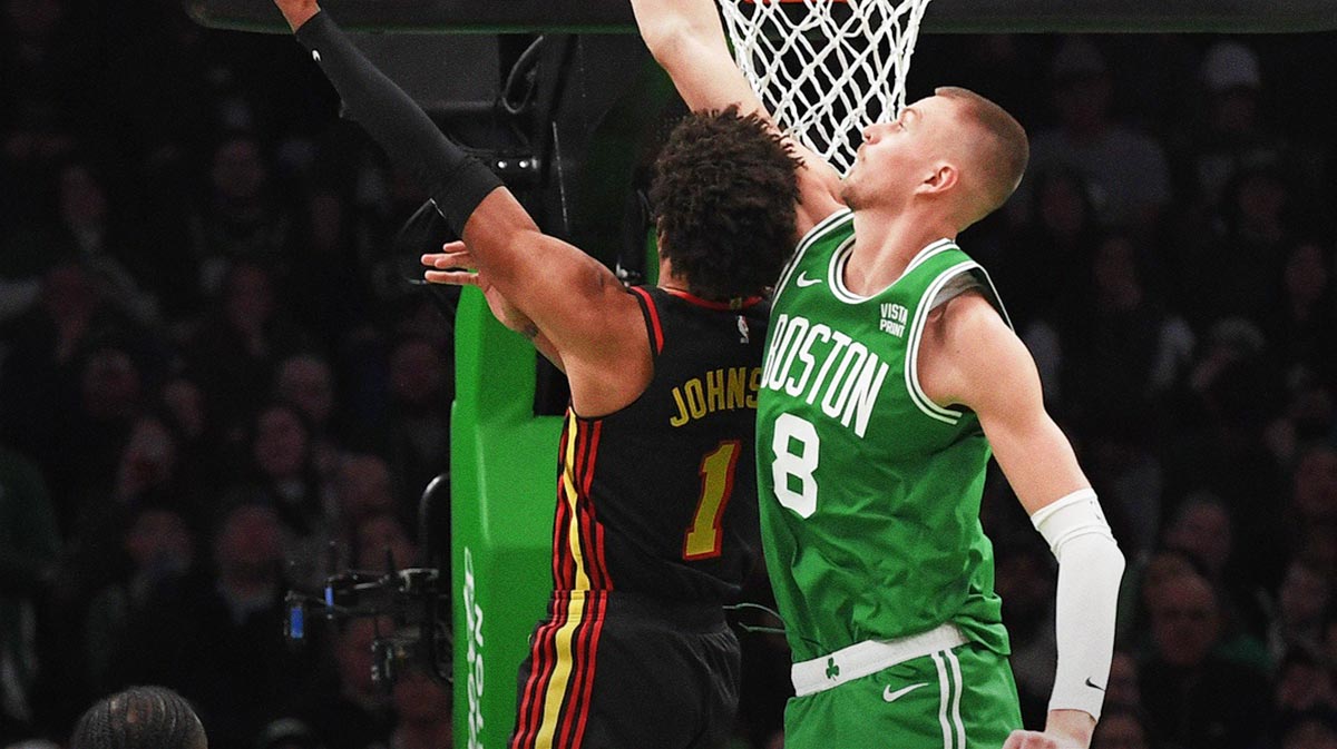 Feb 7, 2024; Boston, Massachusetts, USA; Atlanta Hawks forward Jalen Johnson (1) shoots the ball while Boston Celtics center Kristaps Porzingis (8) defends during the second half at TD Garden. Mandatory Credit: Bob DeChiara-Imagn Images