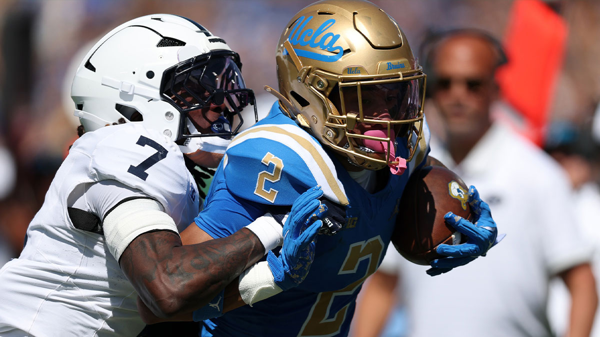 UCLA Bruins wide receiver Titus Mokiao-Atimalala (2) yards after catch against Penn State Nittany Lions cornerback Zion Tracy (7) during the first quarter at Rose Bowl.