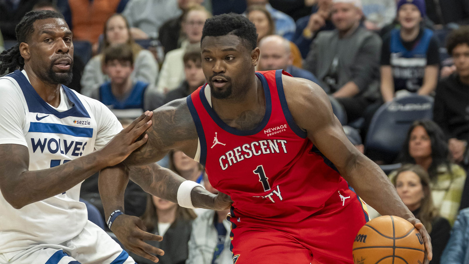 New Orleans Pelicans forward Zion Williamson (1) drives to the basket past Minnesota Timberwolves center Naz Reid (11) in the second half at Target Center. 
