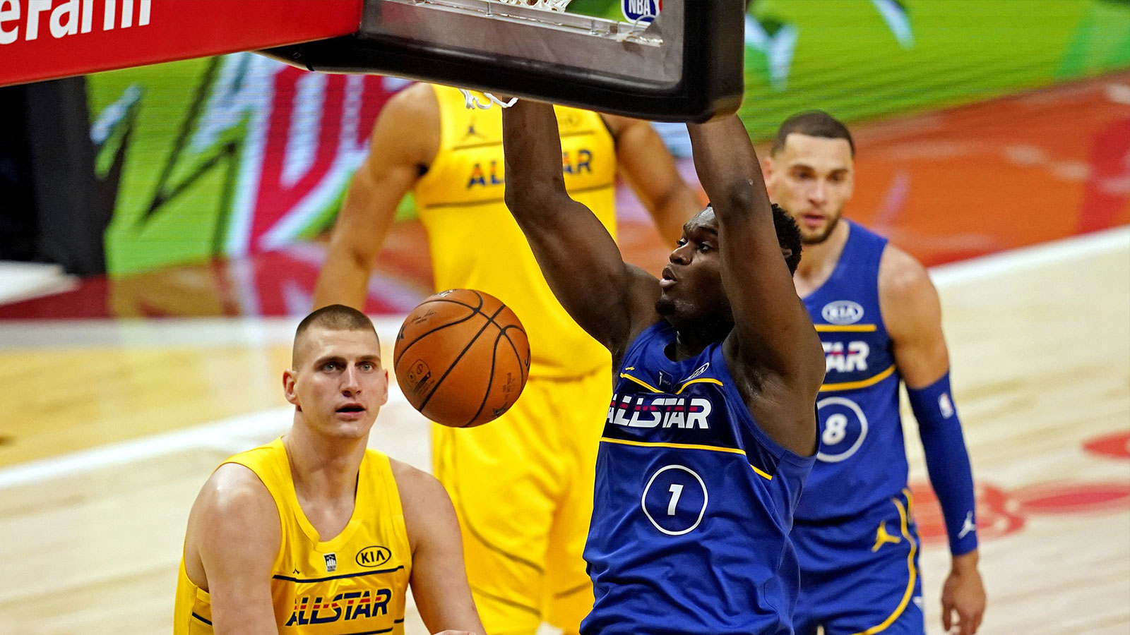 Team Durant forward Zion Williamson of the New Orleans Pelicans (1) dunks the ball against Team LeBron center Nikola Jokic of the Denver Nuggets (15) during the 2021 NBA All-Star Game at State Farm Arena. 