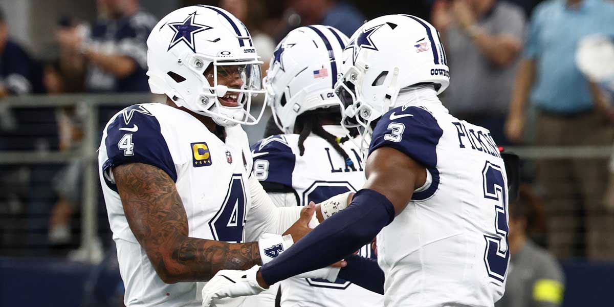 Dallas Cowboys quarterback Dak Prescott (4) and wide receiver George Pickens (3) ceelbrate after a touchdown against the Washington Commanders during the third quarter of the game at AT&T Stadium.