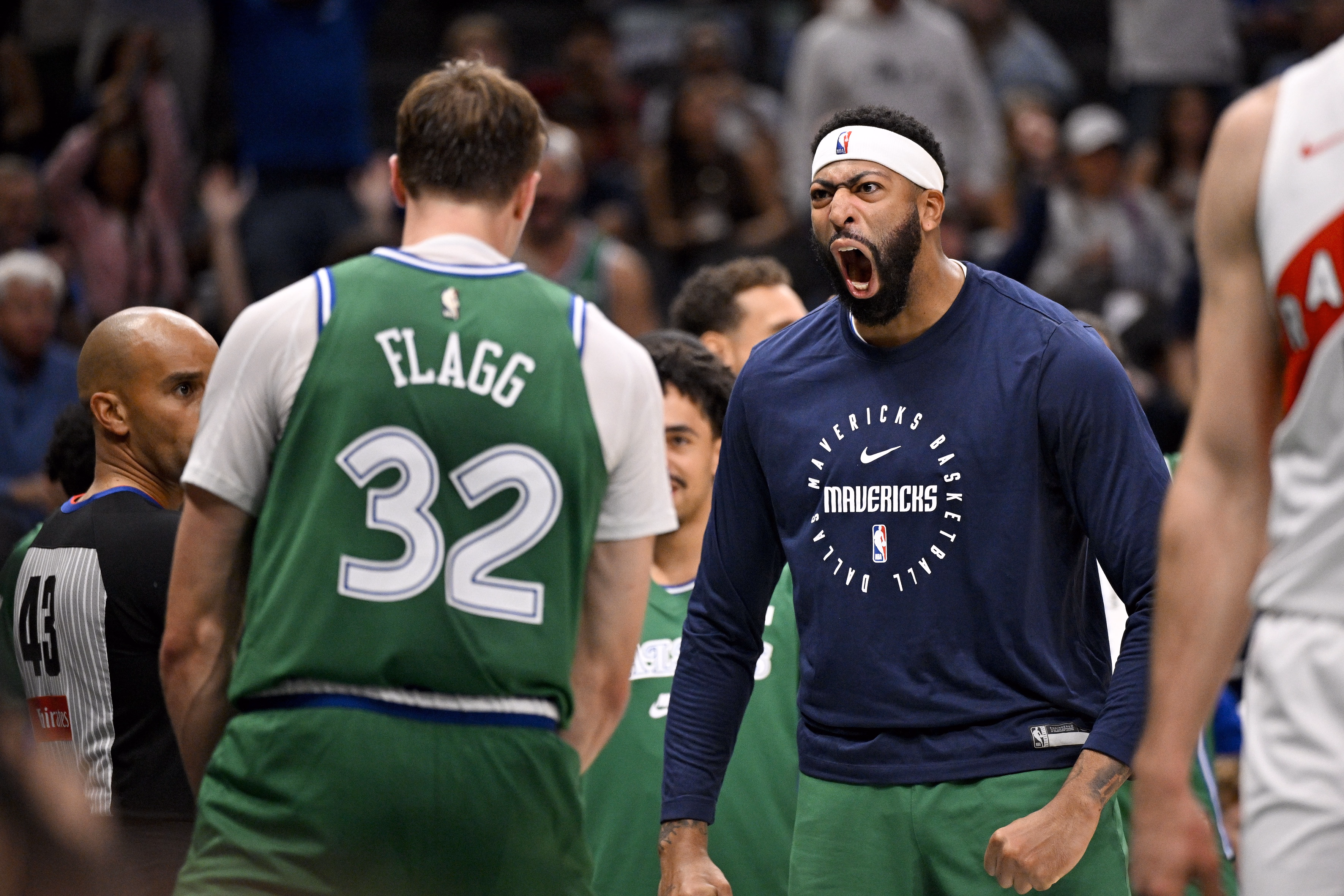 Dallas Mavericks forward Cooper Flagg (32) and forward Anthony Davis (3) celebrates after Flagg dunks the ball against the Toronto Raptors during the third quarter at the American Airlines Center.
