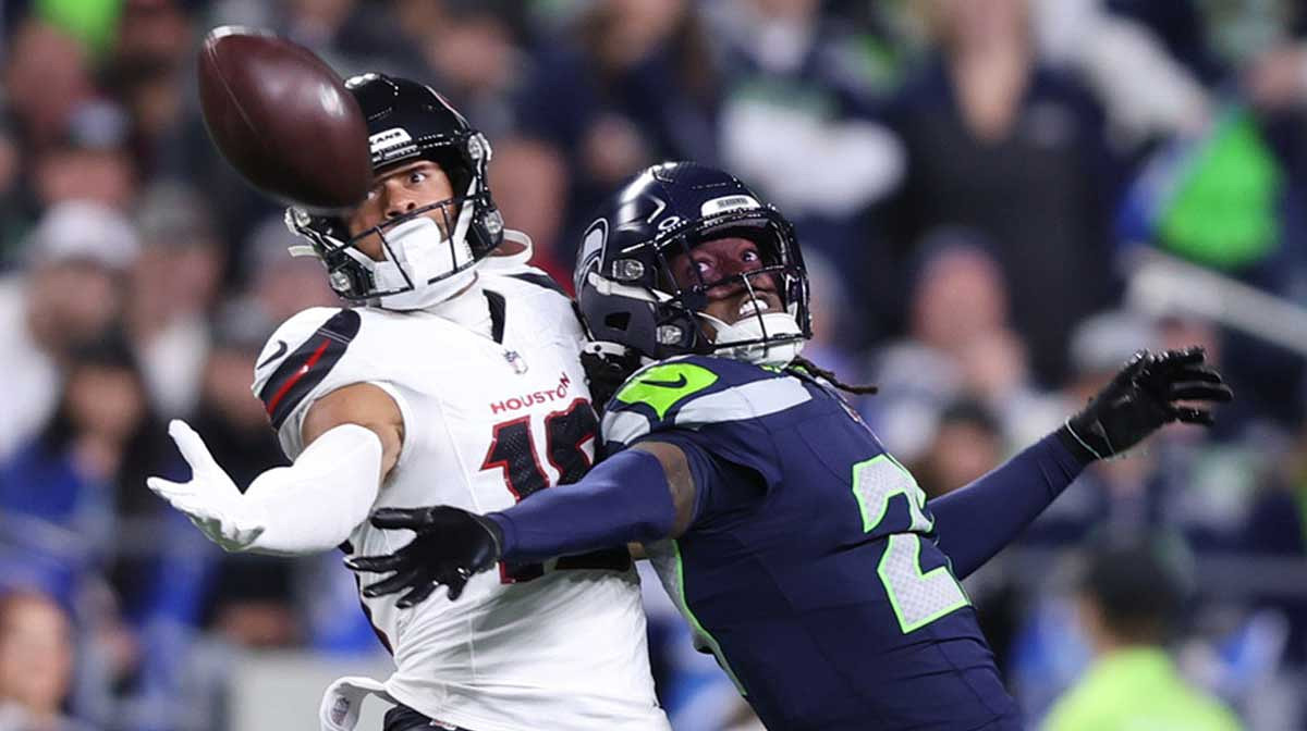 Seattle Seahawks cornerback Riq Woolen (27) defends a pass intended for Houston Texans wide receiver Xavier Hutchinson (19) during the fourth quarter at Lumen Field.