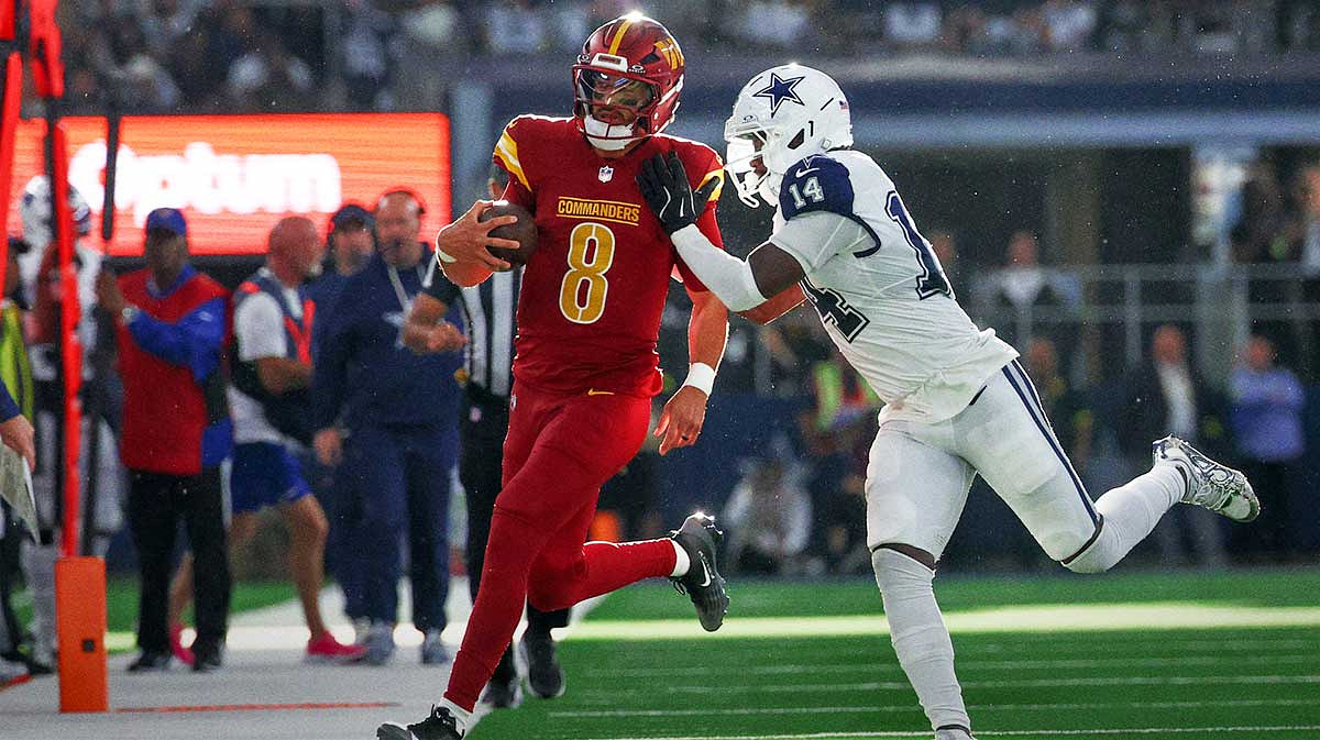 Dallas Cowboys safety Markquese Bell (14) pushes Washington Commanders quarterback Marcus Mariota (8) out of bounds during the third quarter of the game at AT&T Stadium.