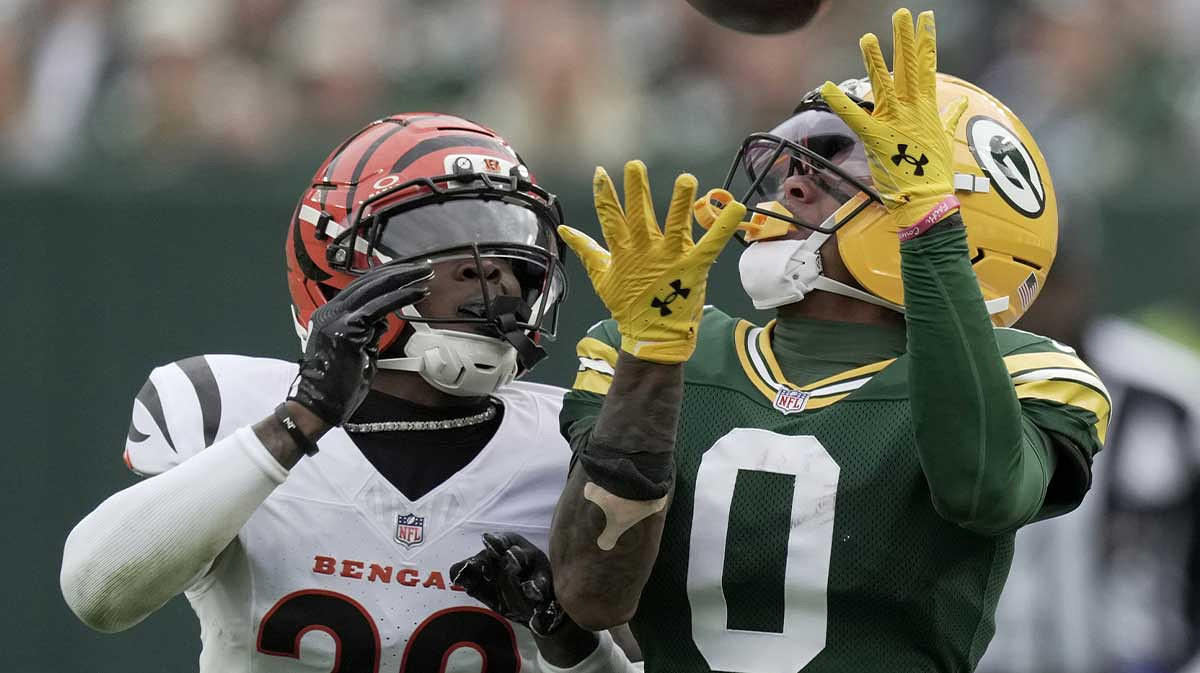 Green Bay Packers wide receiver Matthew Golden (0) makes a 45-yard reception while being covered by Cincinnati Bengals cornerback Cam Taylor-Britt (29) during the second quarter of their game at Lambeau Field.