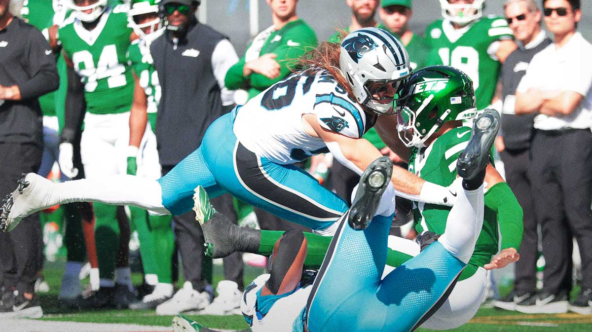 New York Jets quarterback Justin Fields (7) is tackled by Carolina Panthers linebacker Christian Rozeboom (56) in the second quarter at MetLife Stadium.