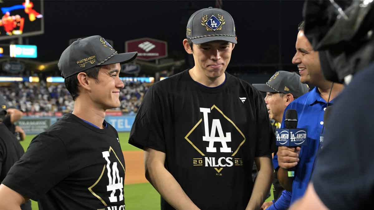 Los Angeles Dodgers pitcher Roki Sasaki (11), center, is interviewed after defeating the Philadelphia Phillies.