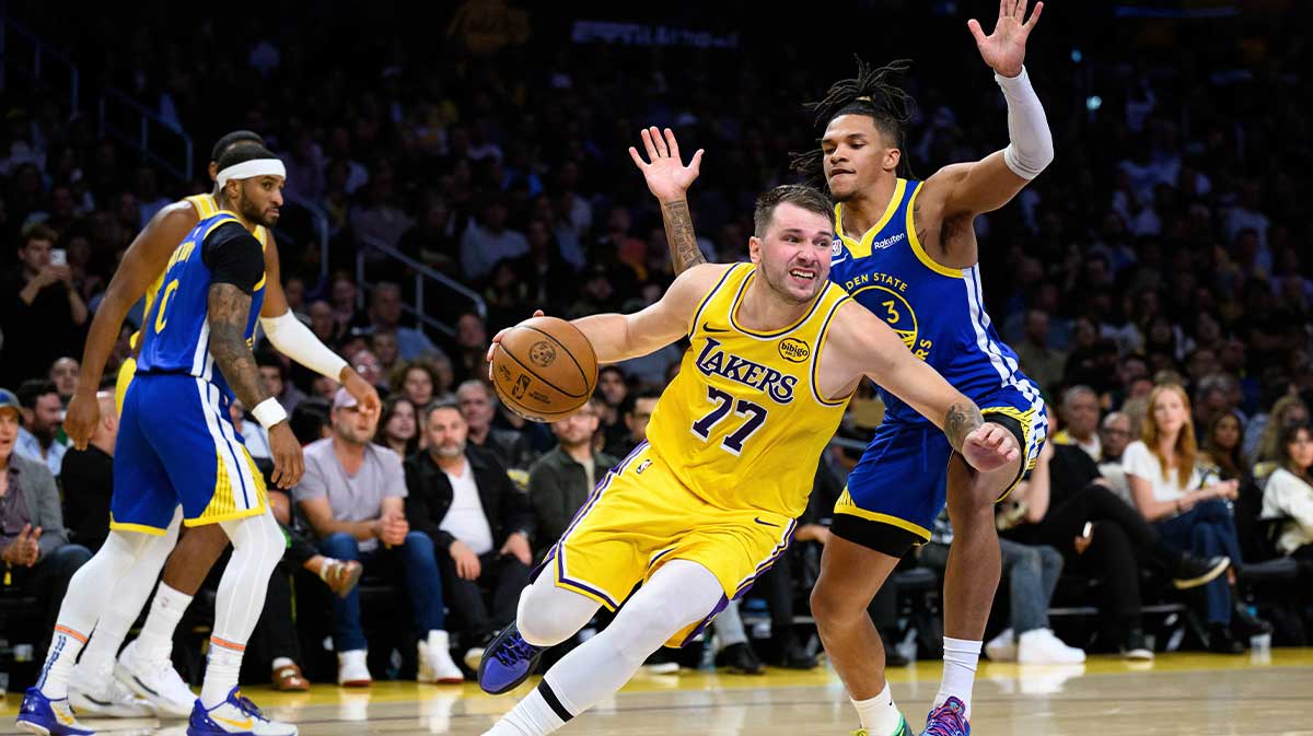 Los Angeles Lakers guard Luka Doncic (77) drives past Golden State Warriors guard Will Richard (3) during the first half at Crypto.com Arena.