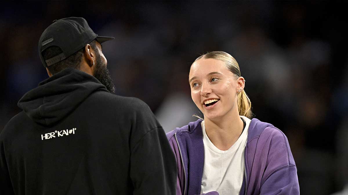 Dallas Mavericks guard Kyrie Irving (left) talks with Dallas Wings guard Paige Bueckers (right) during the second half of the game between the Mavericks and the Oklahoma City Thunder at Dickie's Arena.