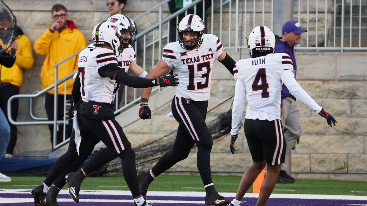 Texas Tech Red Raiders linebacker Ben Roberts (13) celebrates with safety Brenden Jordan (7) and cornerback Maurion Horn (4) after intercepting a pass against the Kansas State Wildcats during the fourth quarter at Bill Snyder Family Football Stadium.