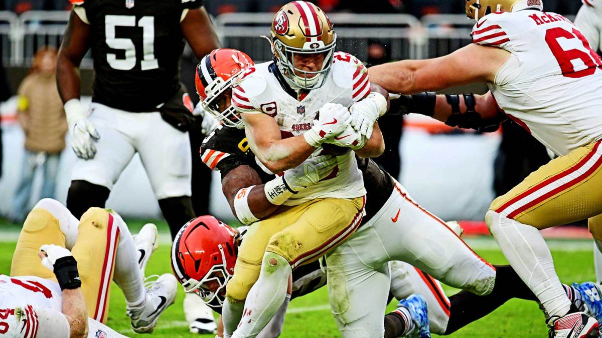 ; San Francisco 49ers running back Christian McCaffrey (23) is tackled by Cleveland Browns defensive end Myles Garrett (95) during the second half at Huntington Bank Field.