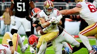 ; San Francisco 49ers running back Christian McCaffrey (23) is tackled by Cleveland Browns defensive end Myles Garrett (95) during the second half at Huntington Bank Field.