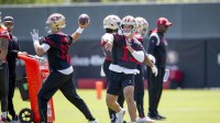 San Francisco 49ers quarterbacks Mac Jones (10) and Brock Purdy (13) work on passing drills during a team OTA at Levi's Stadium