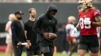 Still recovering from knee surgery, San Francisco 49ers wide receiver Brandon Aiyuk (left) hangs out with teammate George Kittle (85) during the second day of training camp.