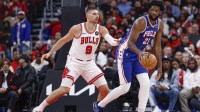 Chicago Bulls center Nikola Vucevic (9) defends against Philadelphia 76ers center Joel Embiid (21) during the first half at United Center.