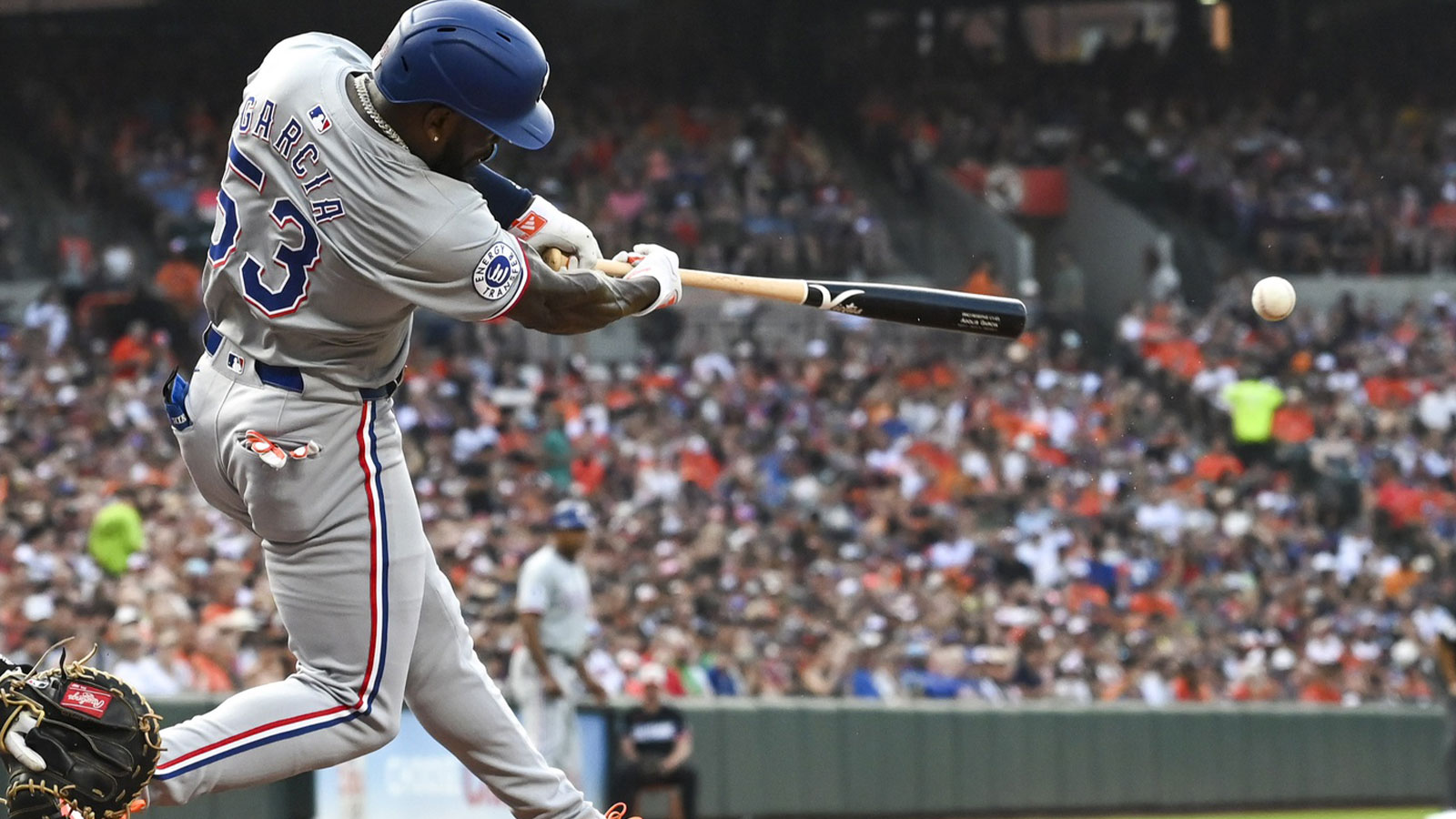 Texas Rangers outfielder Adolis García (53) swings through a first inning double against the Baltimore Orioles at Oriole Park at Camden Yards. 