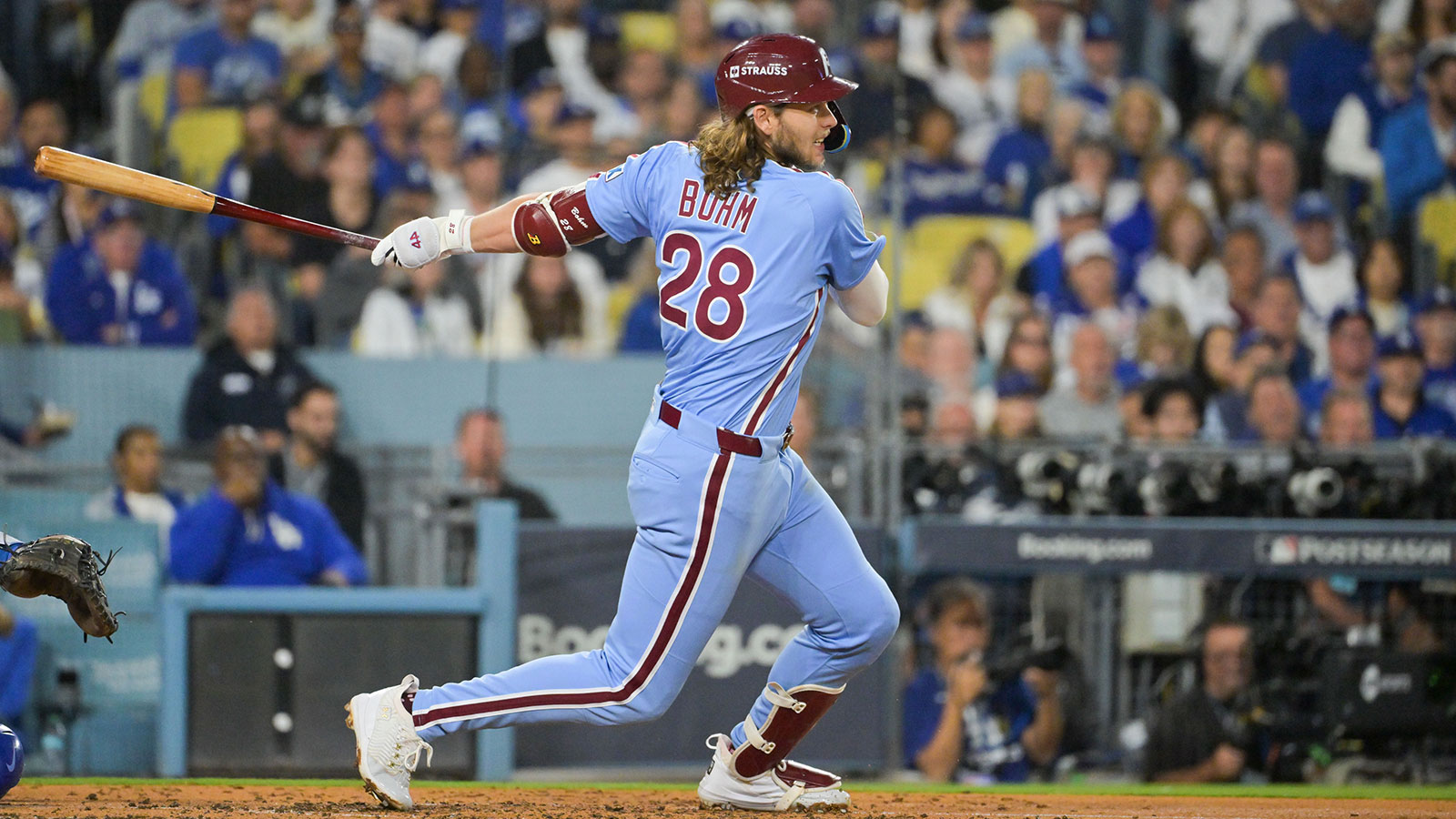 Philadelphia Phillies third baseman Alec Bohm (28) hits a single during the fourth inning against the Los Angeles Dodgers during game three of the NLDS round for the 2025 MLB playoffs at Dodger Stadium. 