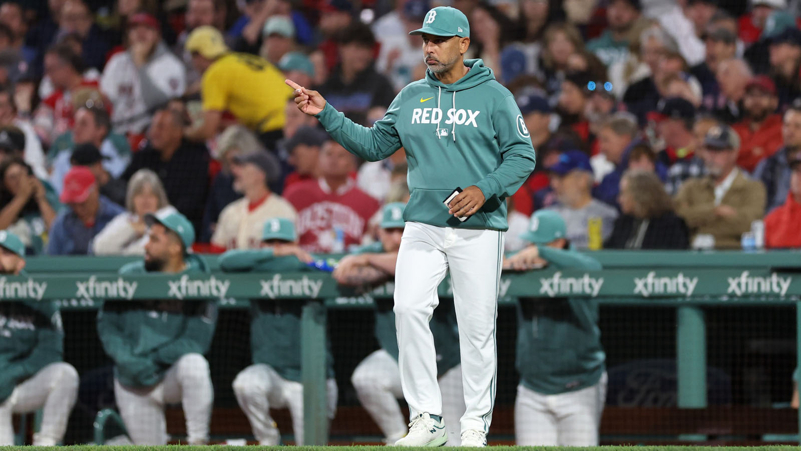 Boston Red Sox manager Alex Cora (13) signals to the bullpen during the sixth inning against the New York Yankees at Fenway Park.