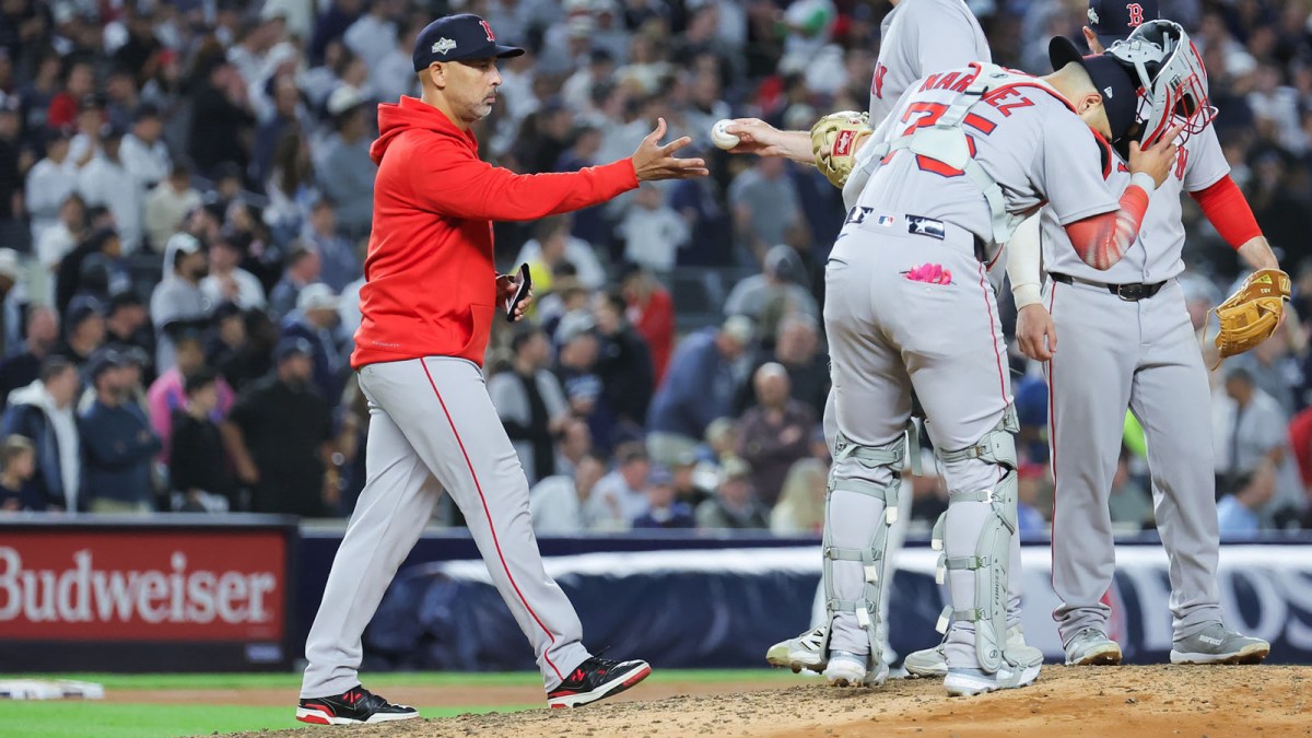 Boston Red Sox manager Alex Cora (13) makes a pitching change during the fifth inning against the New York Yankees during game two of the Wildcard round for the 2025 MLB playoffs at Yankee Stadium.