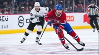 Montreal Canadiens center Alex Newhook (15) plays the puck against Los Angeles Kings right wing Joel Armia (40) during the first period at Bell Centre