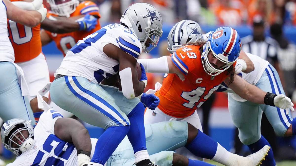 Denver Broncos linebacker Alex Singleton (49) tackles Dallas Cowboys running back Javonte Williams (33) in the second quarter at Empower Field at Mile High.
