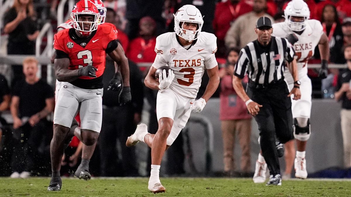 Texas Longhorns wide receiver Emmett Mosley V (3) runs the ball against Georgia Bulldogs linebacker CJ Allen (3) in the first half at Sanford Stadium