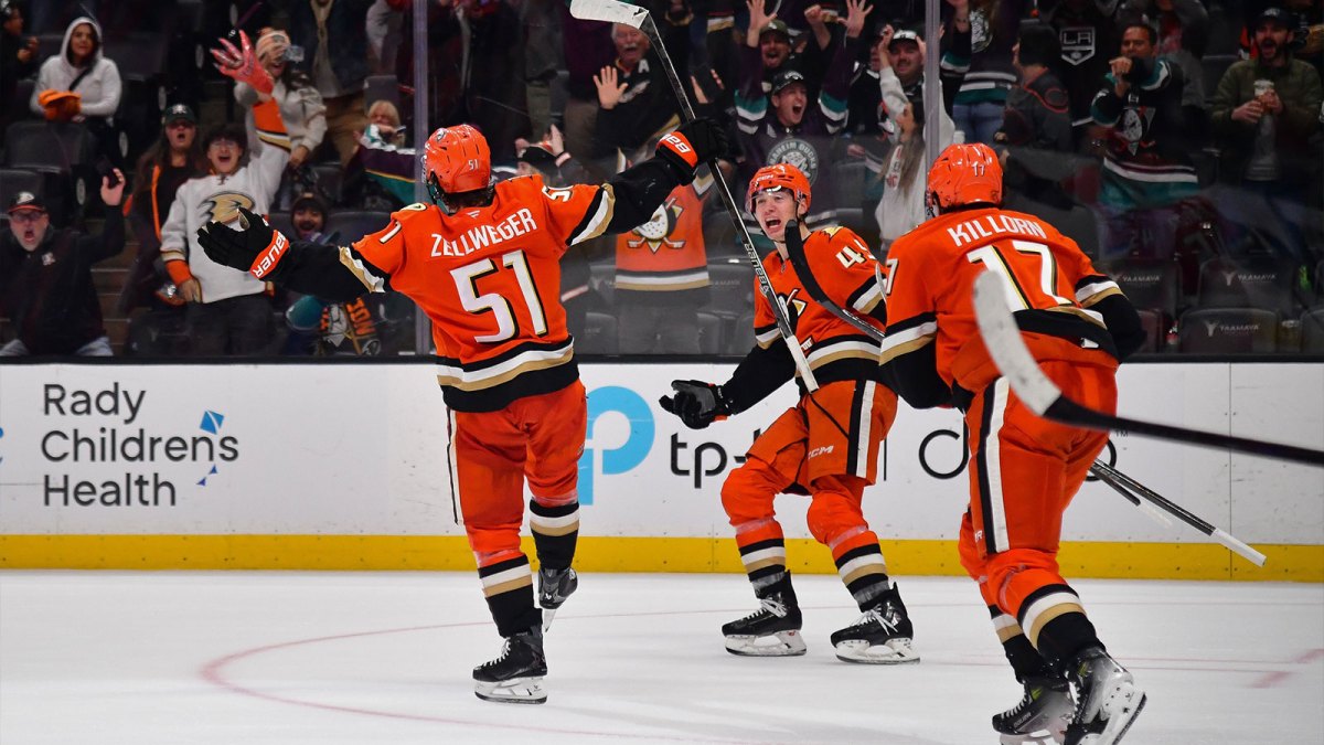 Anaheim Ducks defenseman Olen Zellweger (51) celebrates his goal scored against the Utah Mammoth with right wing Beckett Sennecke (45) and left wing Alex Killorn (17) against the Utah Mammoth in the overtime period at Honda Center.