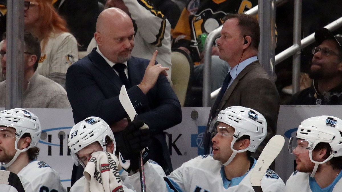 Utah Hockey Club head coach Andre' Tourigney (left rear) gestures on the bench against the Pittsburgh Penguins during the third period at PPG Paints Arena