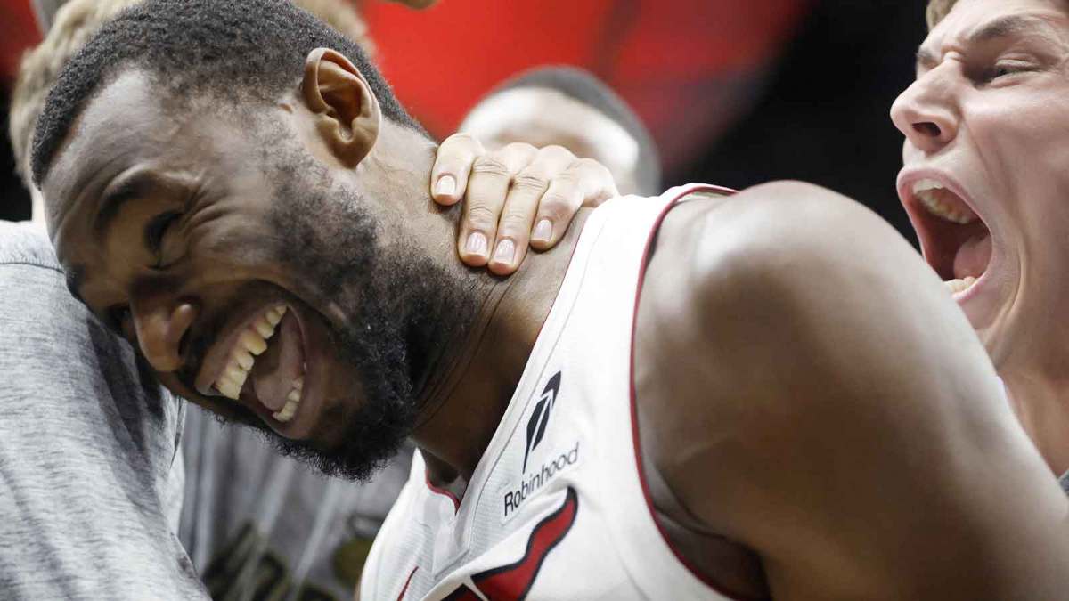 Miami Heat forward Andrew Wiggins (22) reacts to winning the game with teammates against the Cleveland Cavaliers during overtime at Kaseya Center.