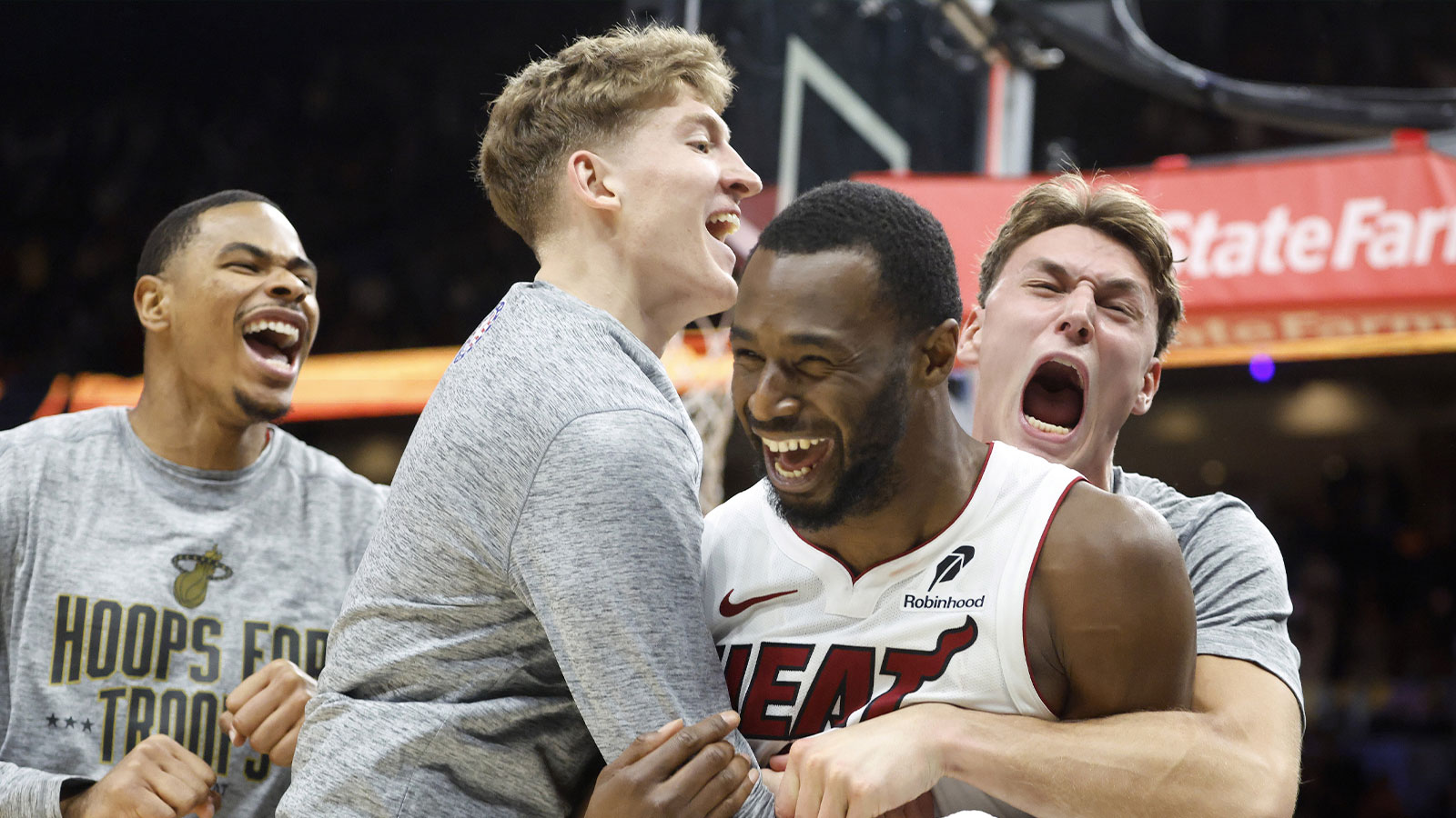 Miami Heat forward Andrew Wiggins (22) reacts to winning the game with teammates against the Cleveland Cavaliers during overtime at Kaseya Center