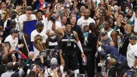 Milwaukee Bucks forward Giannis Antetokounmpo (34) celebrates with the NBA Finals MVP Trophy following the game against the Phoenix Suns following game six of the 2021 NBA Finals at Fiserv Forum.