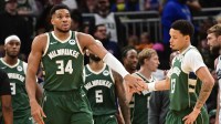 Milwaukee Bucks forward Giannis Antetokounmpo (34) reacts with guard Ryan Rollins (13) after scoring a basket in the 3rd quarter against the Sacramento Kings at Fiserv Forum.