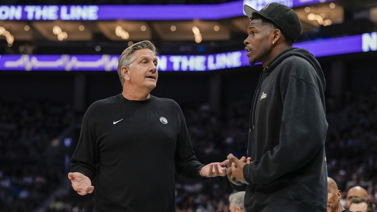 Minnesota Timberwolves head coach Chris Finch talks with guard Anthony Edwards (5) after being called for a penalty during the second quarter against the Charlotte Hornets at Spectrum Center.