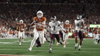 Texas Longhorns quarterback Arch Manning keeps the ball and runs for a touchdown during the second half against the Texas A&M Aggies at Darrell K Royal-Texas Memorial Stadium.