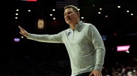 Arizona Wildcats head coach Tommy Llyod talks to the referee from the sidelines against the Utah Utes during the second half at McKale Center
