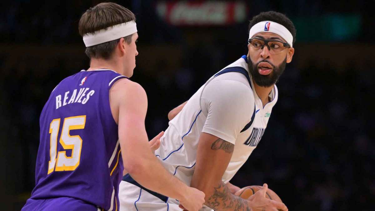 Los Angeles Lakers guard Austin Reaves (15) defends Dallas Mavericks forward Anthony Davis (3) in the second half at Crypto.com Arena.