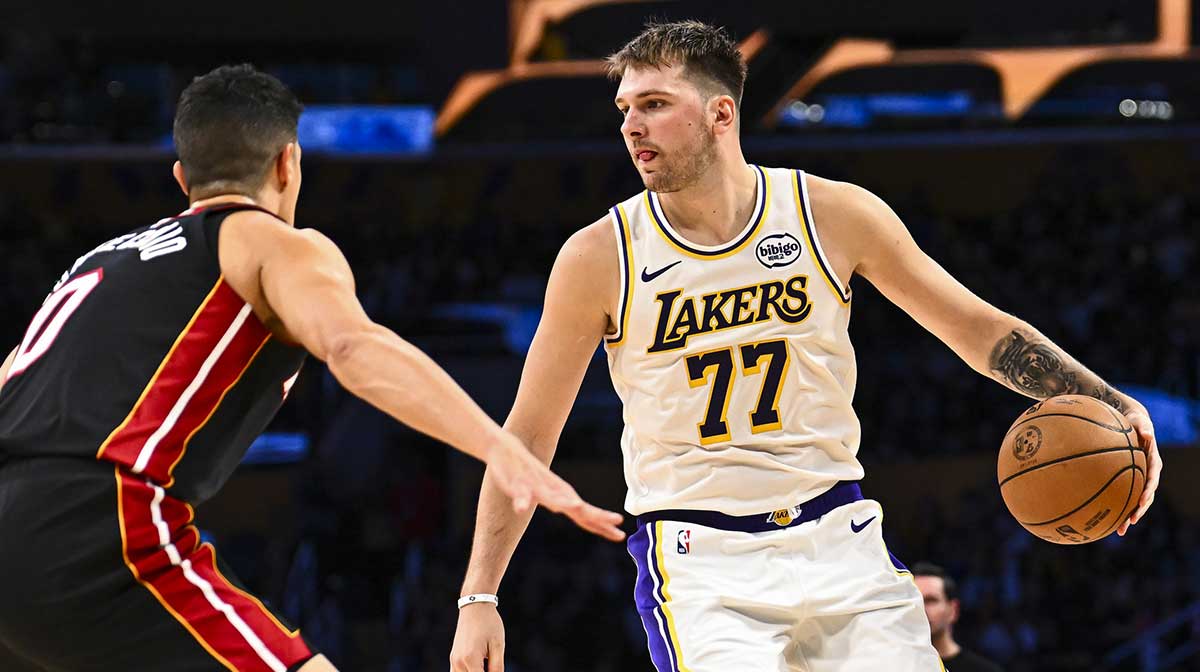 Los Angeles Lakers guard Luka Doncic (77) looks to pass against Miami Heat forward Simone Fontecchio (0) during the second half at Crypto.com Arena.