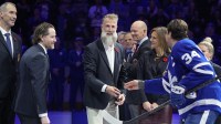 Hockey Hall of Fame inductee Joe Thornton reacts as Toronto Maple Leafs forward Auston Matthews (34) hands him the ceremonial puck as other Hall of Famers Zdeno Chara, Duncan Keith, Matts Sundin, and Jennifer Botteril (left to right) look on before the start of the game against the Carolina Hurricanes at Scotiabank Arena.