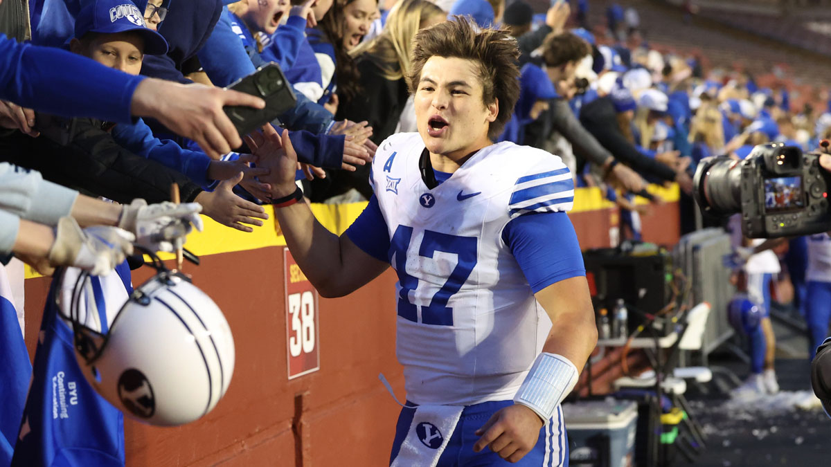 Cougars quarterback Bear Bachmeier (47) celebrates with fans after the Cougars beat the Iowa State Cyclones at Jack Trice Stadium. 