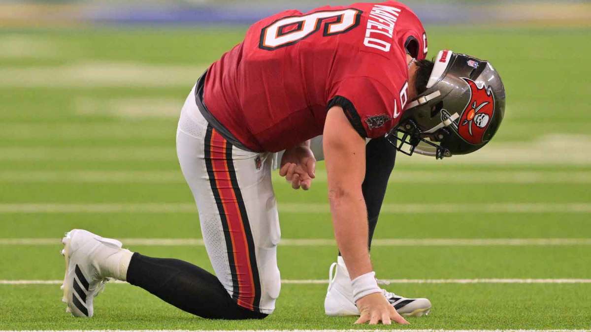 Tampa Bay Buccaneers quarterback Baker Mayfield (6) kneels on the field with an apparent injury against the Los Angeles Rams during the second quarter at SoFi Stadium.