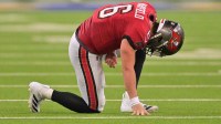 Tampa Bay Buccaneers quarterback Baker Mayfield (6) kneels on the field with an apparent injury against the Los Angeles Rams during the second quarter at SoFi Stadium. Mandatory Credit: Jayne Kamin-Oncea-Imagn Images