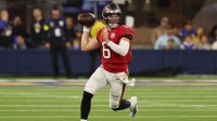 Tampa Bay Buccaneers quarterback Baker Mayfield (6) looks to throw a pass while running with the ball against the Los Angeles Rams during the first quarter at SoFi Stadium