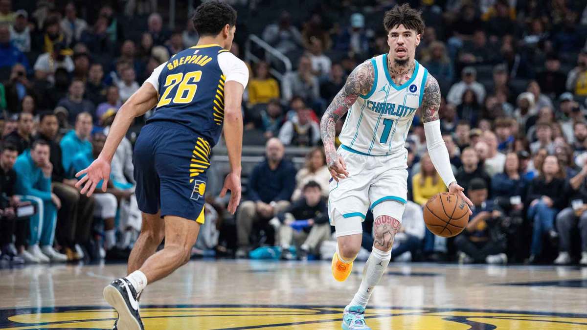 Charlotte Hornets guard LaMelo Ball (1) dribbles the ball while Indiana Pacers guard Ben Sheppard (26) defends in the first half at Gainbridge Fieldhouse.